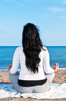 Portrait of beautiful native american girl doing yoga at beach