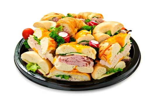 Isolated assorted platter of sandwiches with meat and vegetables