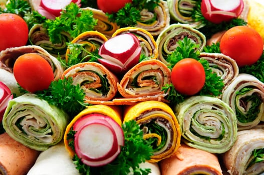 Closeup on platter of assorted meat tortilla wraps