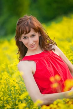 happy woman in red dress in yellow field