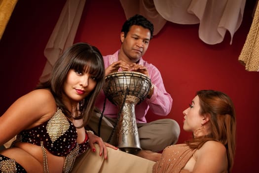 Two gorgeous Arab belly dancers with Indian man playing Sitar