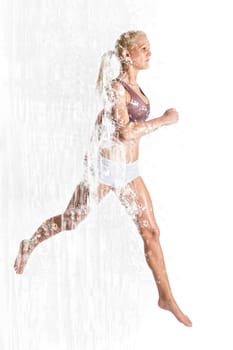 Young woman jogging in front of light background
