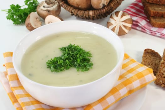 a bowl of cream of mushroom soup with fresh ingredients