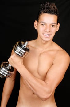 Shirtless smiling young man training with a chrome dumbbell