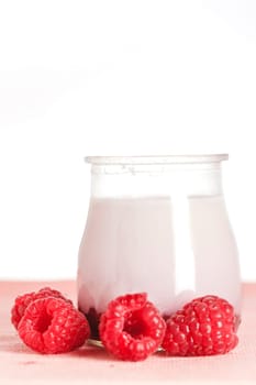 Delicious glass yogurt and fresh raspberries. Shallow depth of field