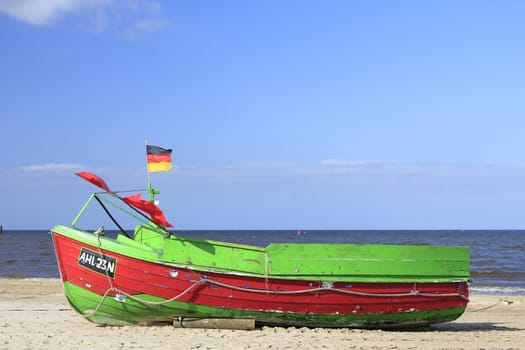 Fishing boat on the beach on the island of Usedom,Baltic Sea,Mecklenburg-Western Pomerania,in the background the pier of Ahlbeck
