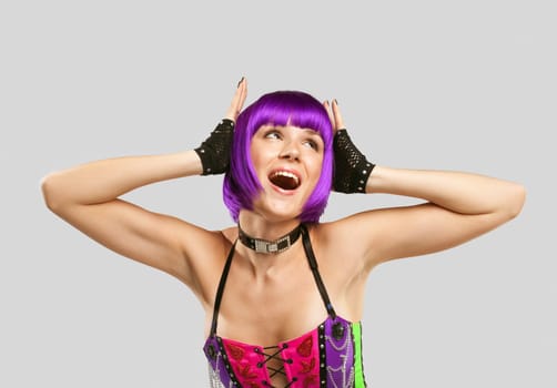 Young beauty Disco singer in purple hairs and corset