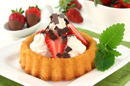 Strawberry tartlets with cream and chocolate sprinkles