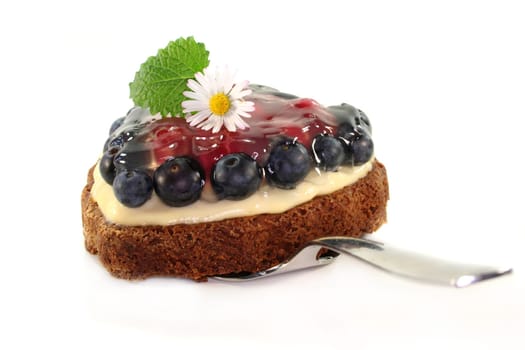 a forest fruit tart on a cake server