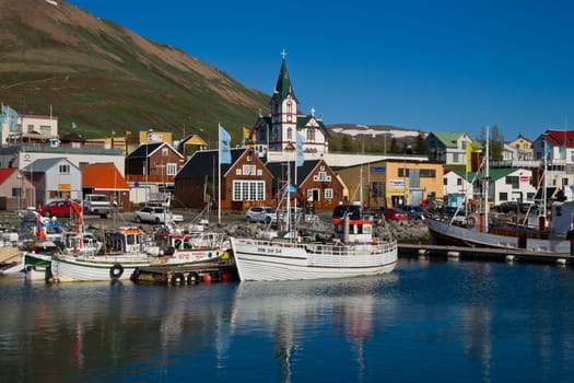 ICELAND,HUSAVIK - June 9th,2010: View across the scenic harbour of the northern icelandic smalltown of Husavik at a sunny summer day. Photo taken on June 9th,2010.