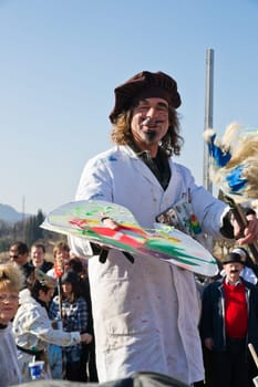 VILLACH,AUSTRIA - MARCH 5: A painter on stilts took the street at the annual carnival procession held on March 5,2011 in Villach,Austria. Participants come from Austria,Italy and Slovenia.