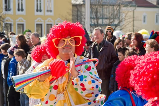 VILLACH,AUSTRIA - MARCH 5: A red-haired clown took the street at the annual carnival procession held on March 5,2011 in Villach,Austria. Participants come from Austria,Italy and Slovenia.