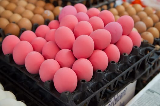 Red eggs for sale at a market in Thailand. Those red eggs are also called hundred-year or pidan eggs and are part of traditional Chinese cuisine.