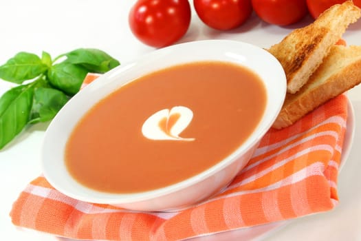 a bowl of tomato cream soup with toast