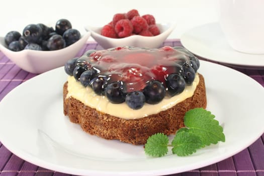 a forest fruit tart on a cake server