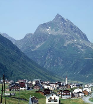 Swiss village with Alps in background