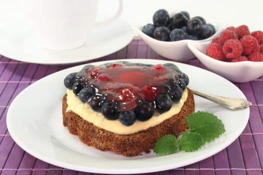 a forest fruit tart on a cake server