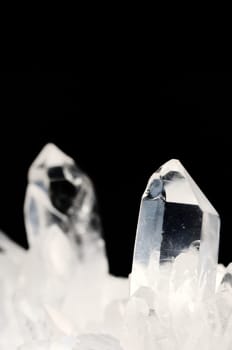 Quartz crystals on black background with copy space
