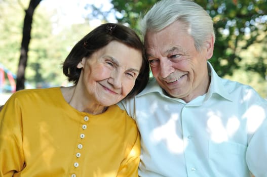 Portrait of happy senior man and woman outdoors in park
