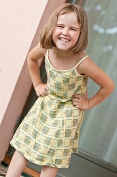 Outdoors portrait of small cute child - standing at door