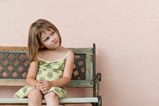 Outdoors portrait of small cute child looking to side with copy space