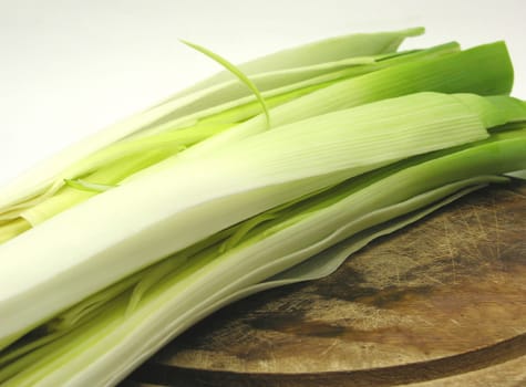 Leek sticks on wooden board in close-up