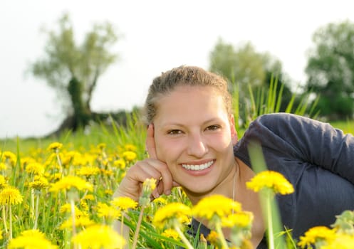 Young woman on a flower meadow