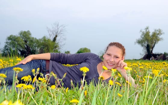 Young woman on a flower meadow