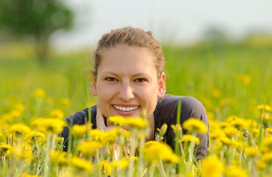 Young woman on a flower meadow