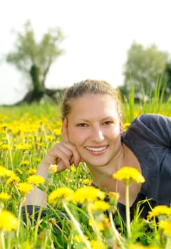 Young woman on a flower meadow