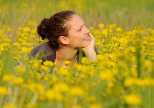 Young woman on a flower meadow