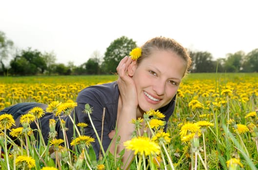 Young woman on a flower meadow