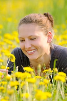Young woman on a flower meadow