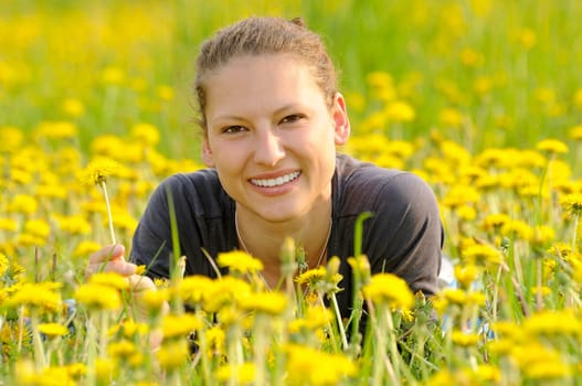 Young woman on a flower meadow