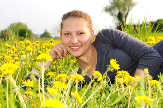 Young woman on a flower meadow