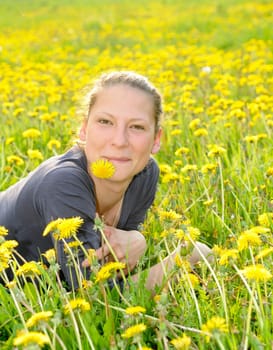 Young woman on a flower meadow