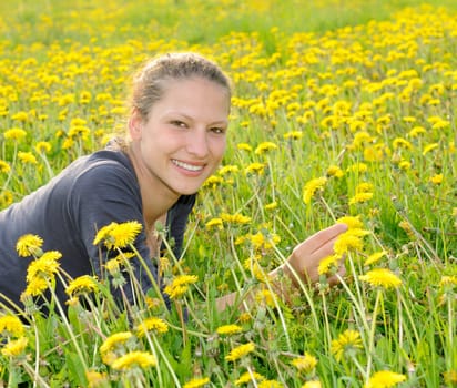 Young woman on a flower meadow
