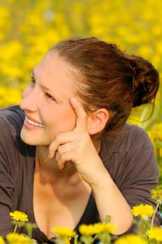 Young woman on a flower meadow