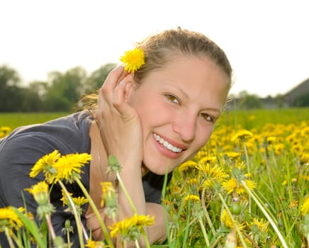 Young woman on a flower meadow