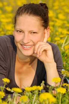 Young woman on a flower meadow