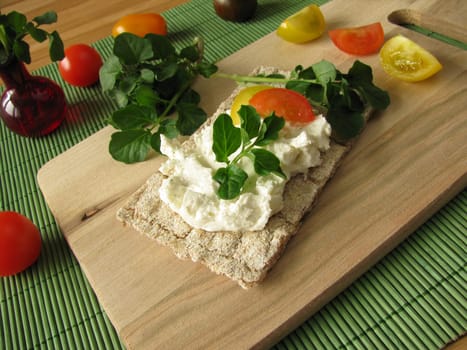 Cream cheese with watercress on crispbread