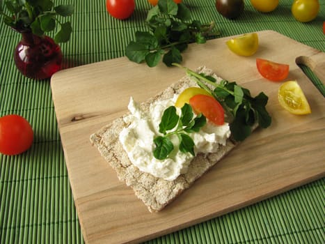 Cream cheese with watercress on crispbread