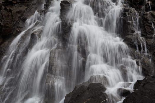 a beautiful waterfall on a mountain slope