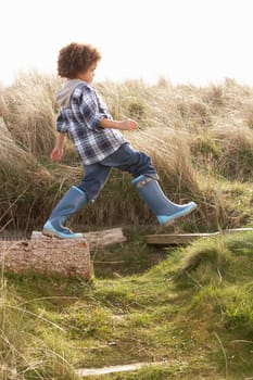 Young Boy Going For Walk In Wellington Boots