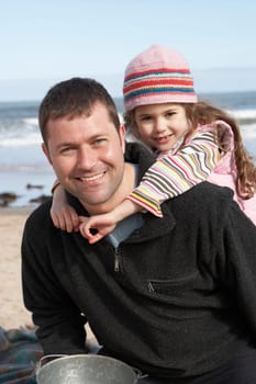 Father And Daughter Having Fun On Beach Together