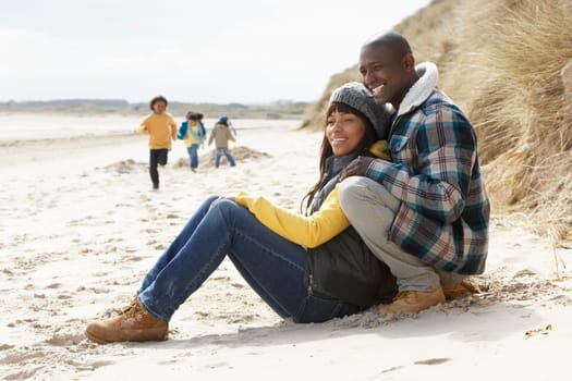 Family Having Fun On Winter Beach