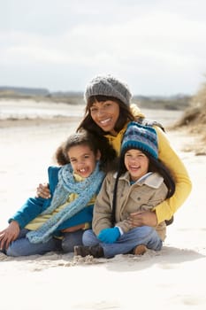 Mother And Children On Winter Beach