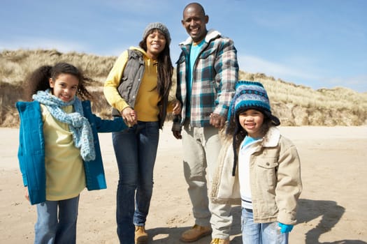 Family Walking On Winter Beach