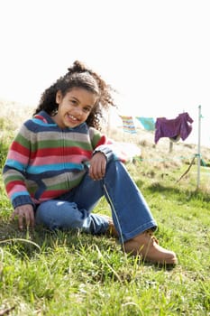 Young Girl Sitting Outside In Caravan Park