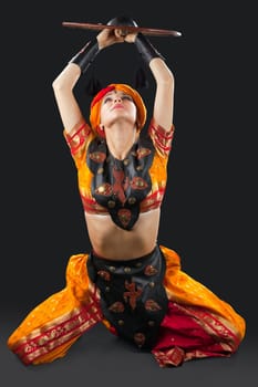 Beauty woman posing with shield - arabian traditional costume